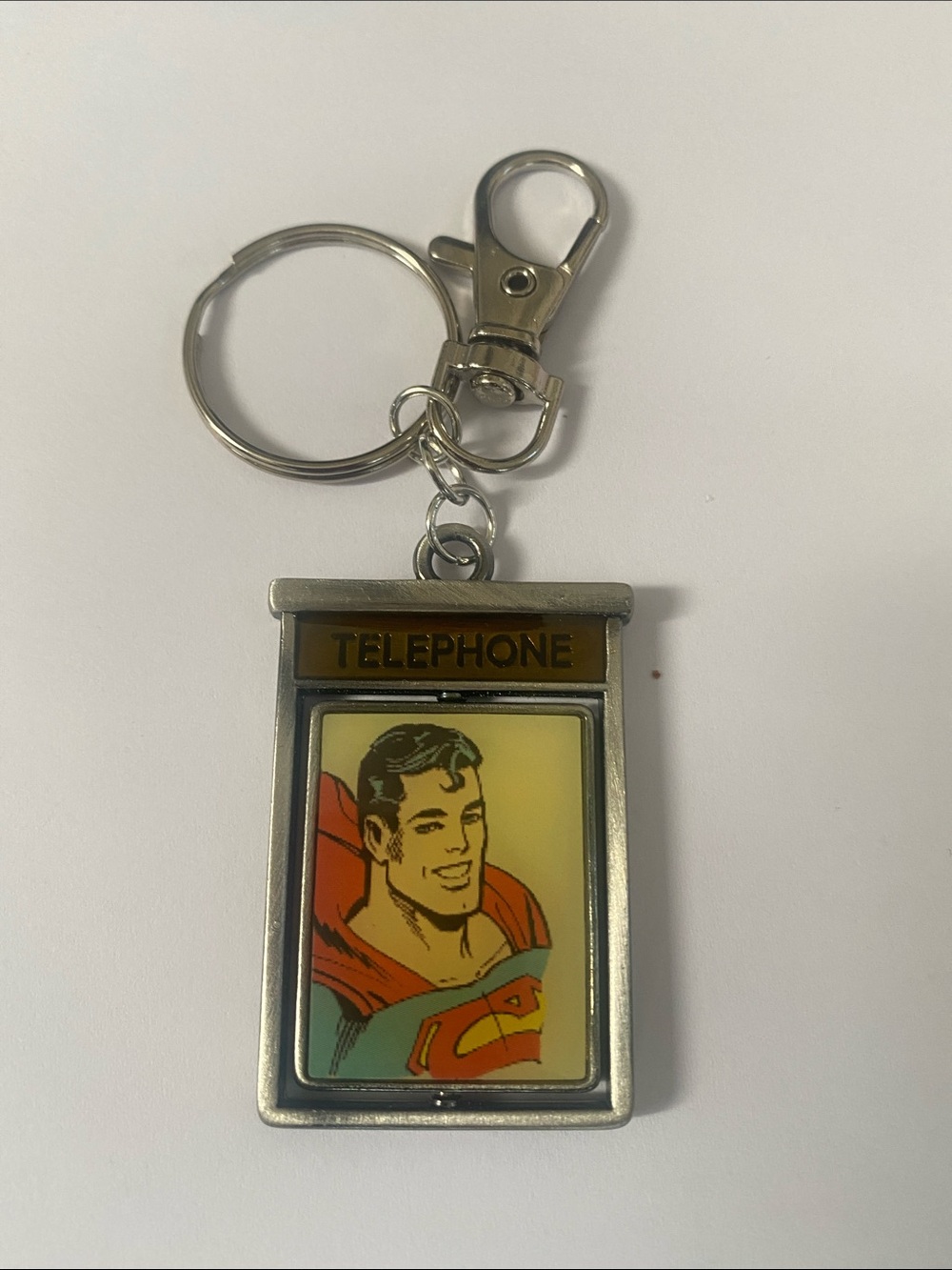 Silver Double Sided Superhero Phone Booth Keychain with Yellow Graphic